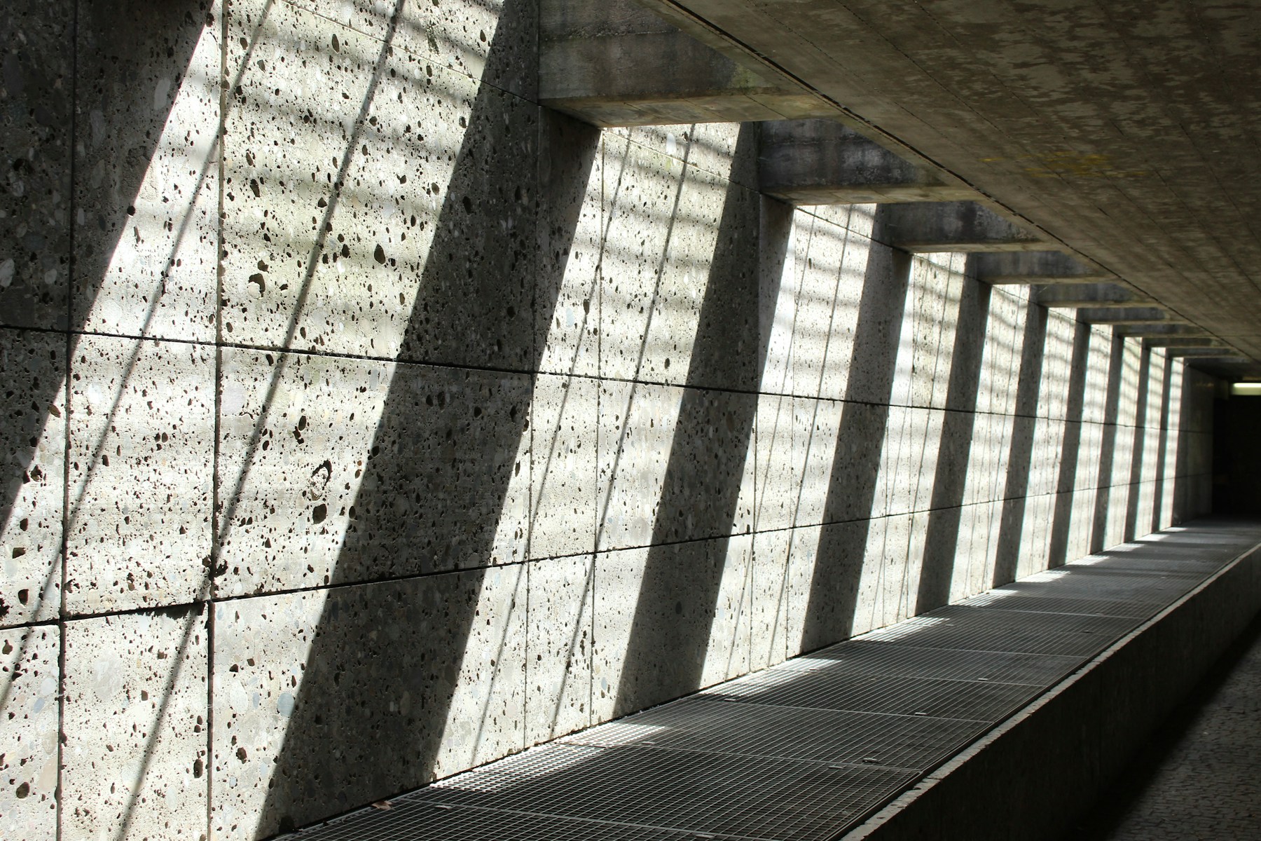 Sunlight and shadows across a quiet architectural space